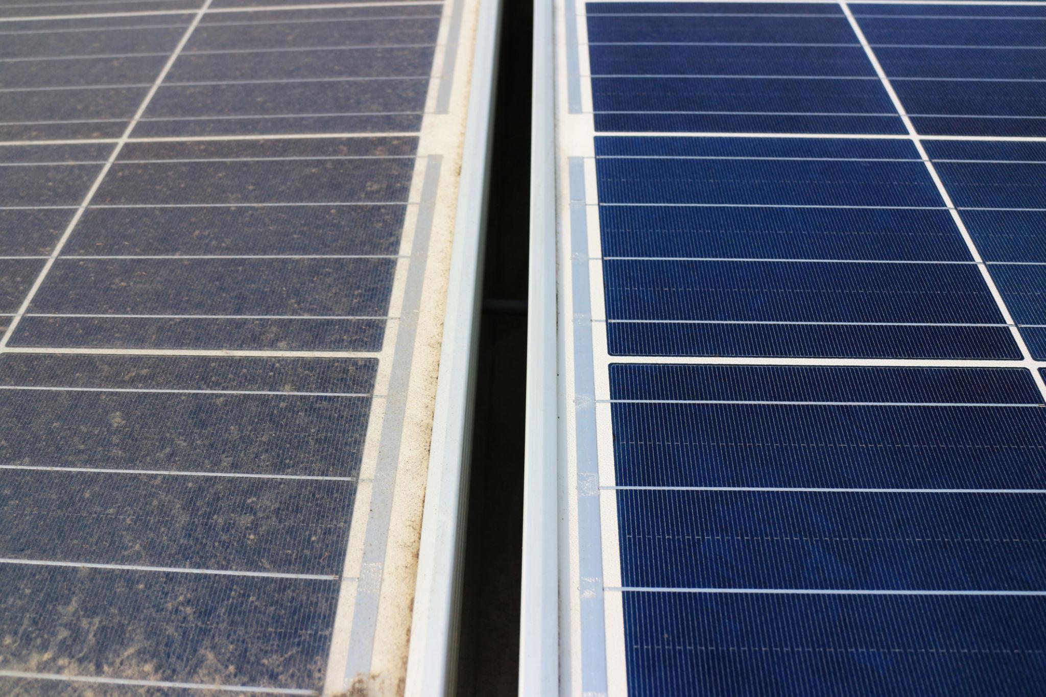 Two adjacent rows of dark blue solar panels separated by a narrow metal gap, with a light frame along the edges.